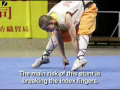 Shaolin monk stands on two fingers